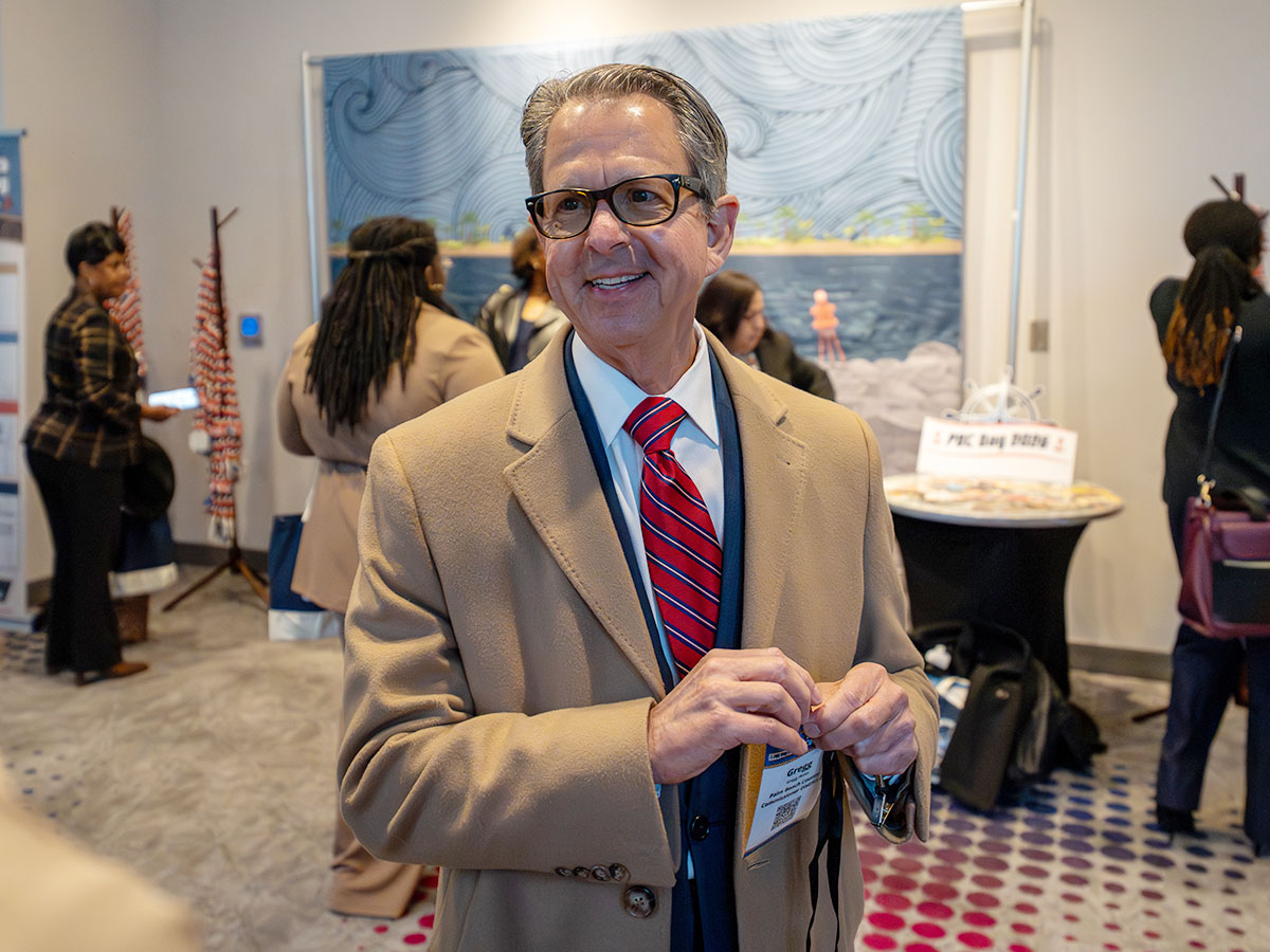 PBC Commissioner Gregg K. Weiss checks in at registration.
